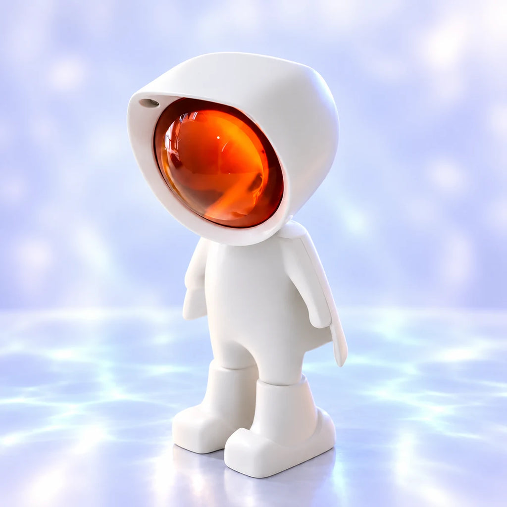 Veilleuse projecteur Iris, petit astronaute blanc à cape avec lentille orange, sur fond lavande lumineux